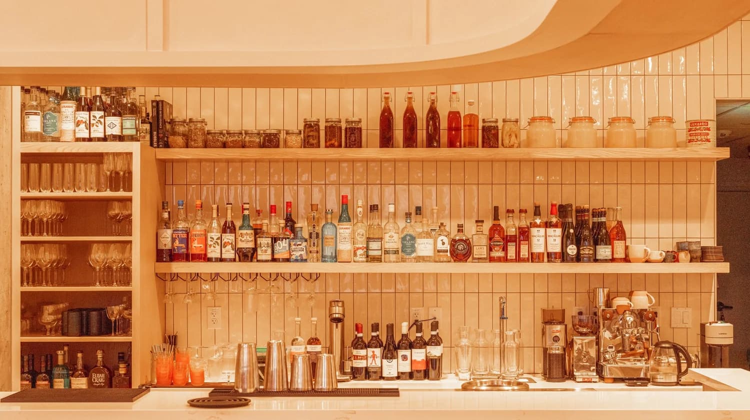 The bar at Emilia, with shelves of amari, spirits and glassware