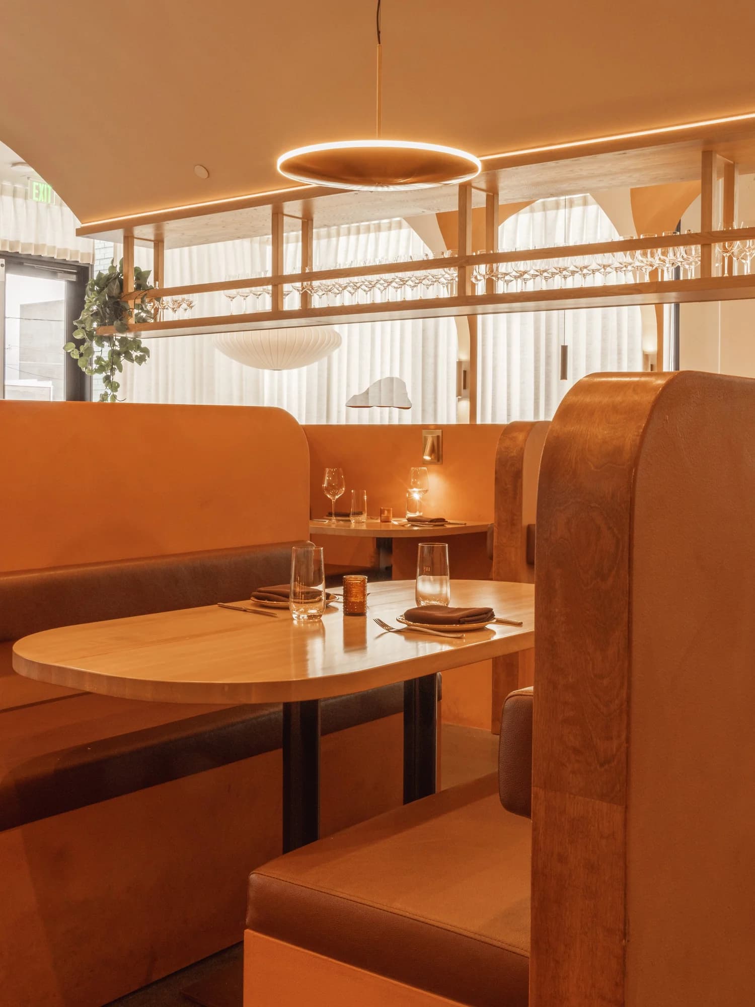 A warm leather booth at Emilia set for two