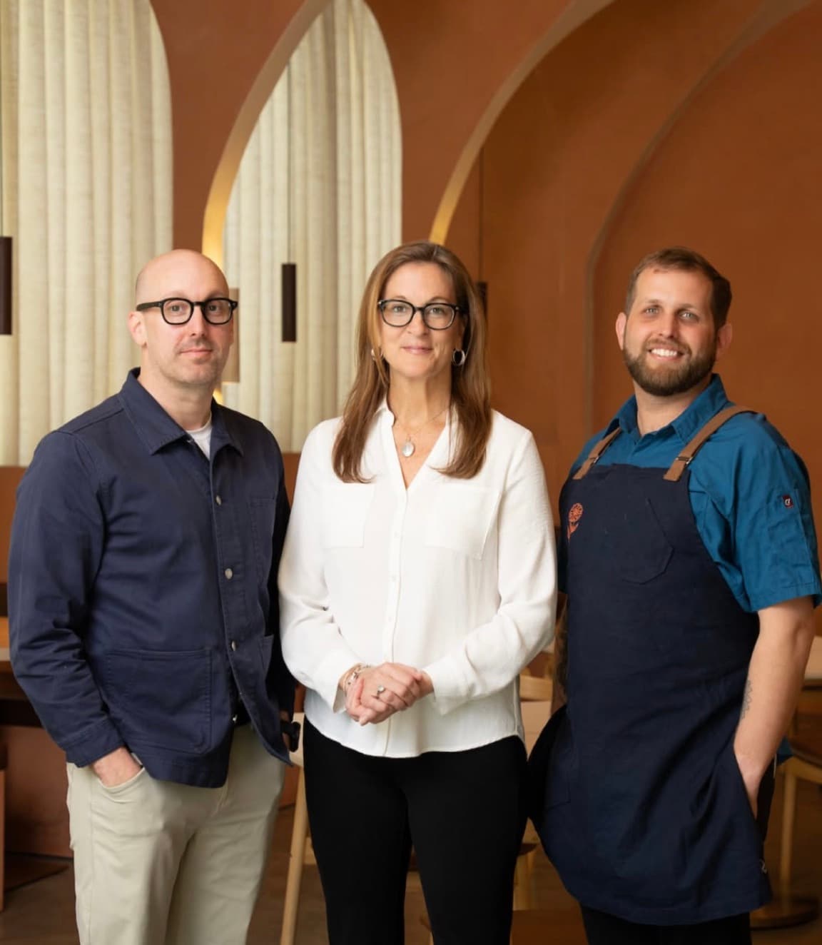 Restaurateurs Ty Leon, Heather Morrison and Austin Carson standing together in the dining room