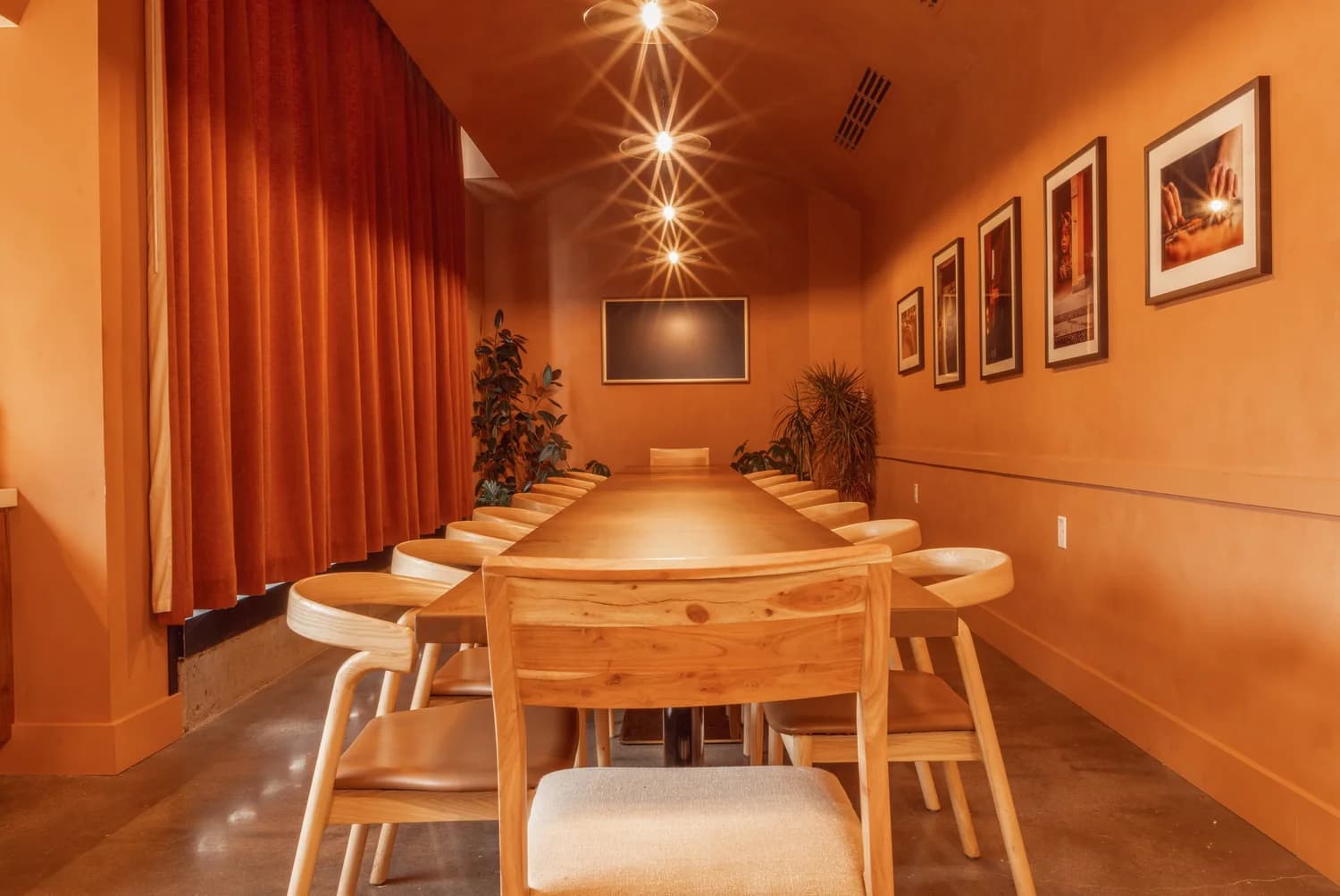 Emilia's private dining room with one long wooden table under warm lights