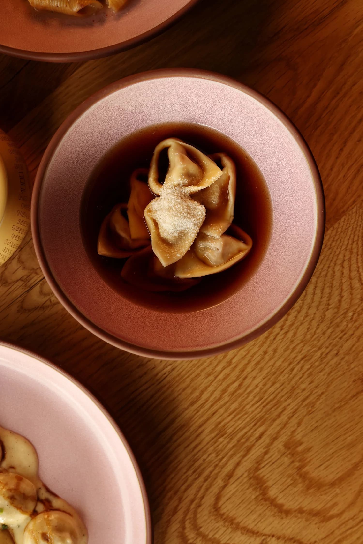 Filled pasta in a warm golden broth